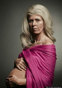 In this photo, 46-year-old Kate Garraway is costumed with gray hair, liver spots, and wrinkles. She’s pregnant and covers her breasts with a shawl (which is fuchsia, the color of First Response boxes), while revealing her pregnant belly
