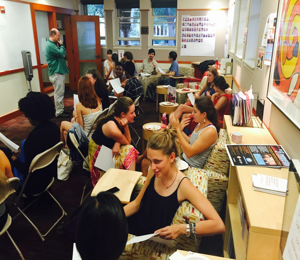 Picture of multiple tutors talking to each other and working collaboratively in small groups in the Hume Center Lounge.