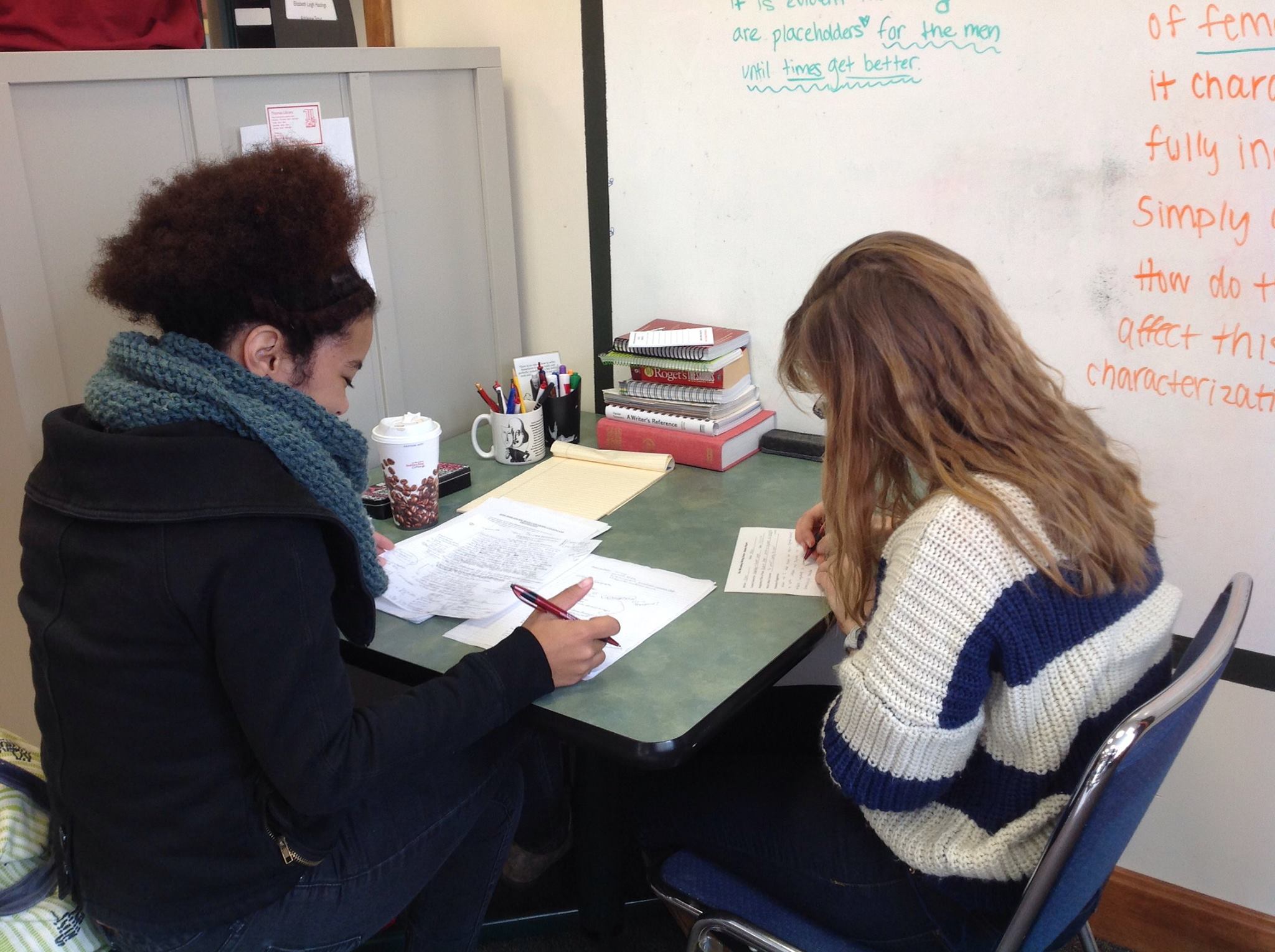Photo of a tutor and a writer at a table.